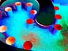 photo of a swimming pool so colorized as to be abstract, circles, checks, uvula, bright red, blue, aqua