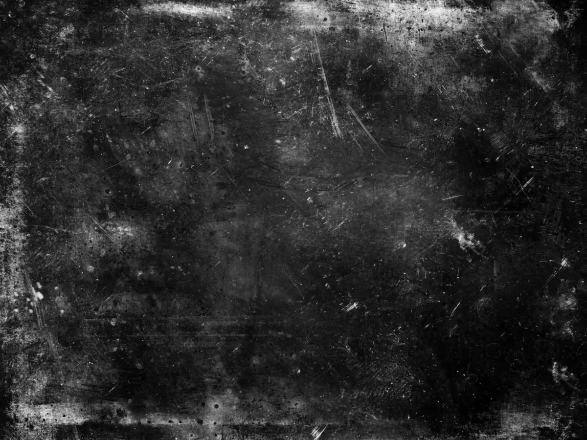 Abstract black and white photo of a textured concrete wall.